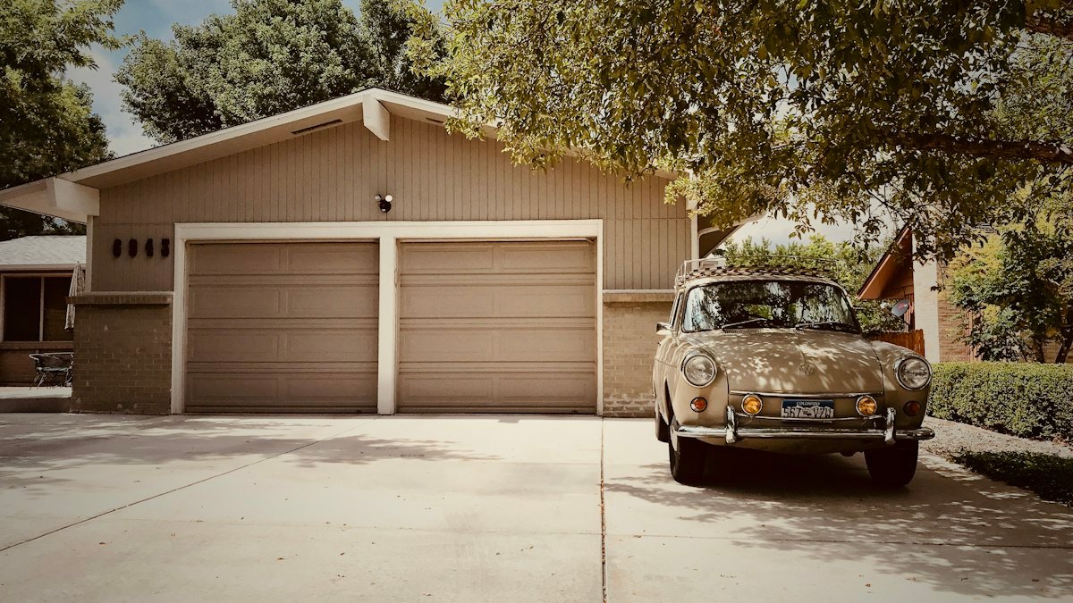 Residential home with twin beige garage doors